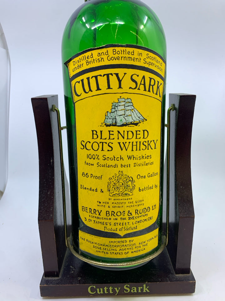 VTG CUTTY SARK WHISKY DISPLAY BOTTLE W/WOODEN SWING CRADLE STAND.