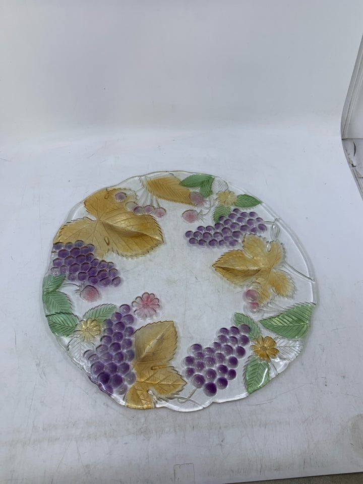 GLASS PLANTED W/ ASSORTED COLORED FRUIT.