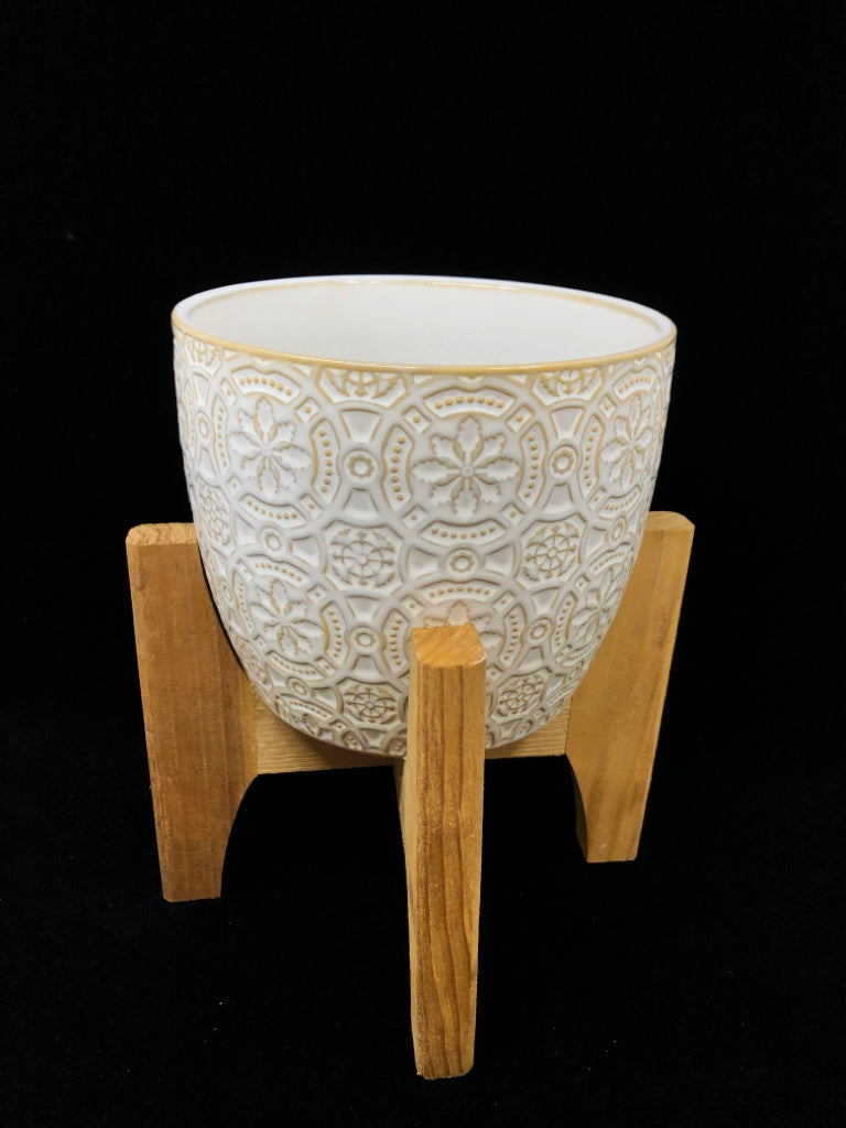 CIRCLE DESIGN CERAMIC PLANTER ON WOOD LEGS.