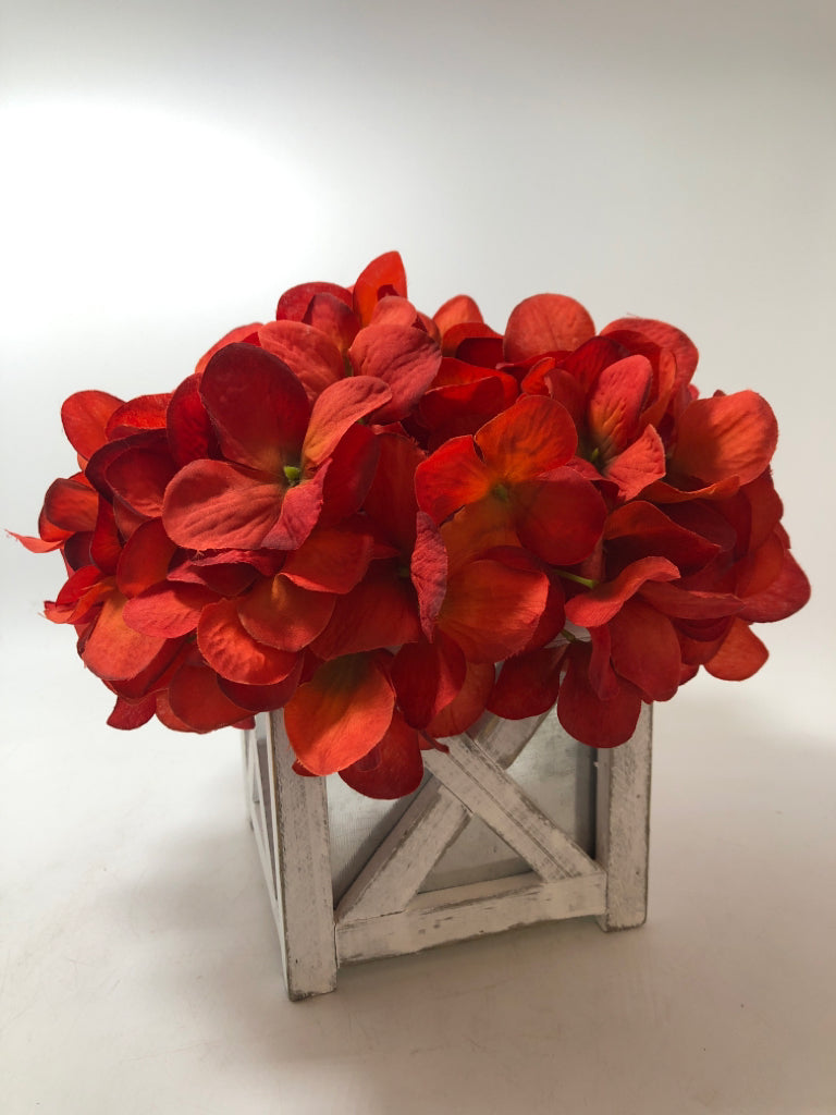 RED FLORALS IN "X" FRAME PLANTER.