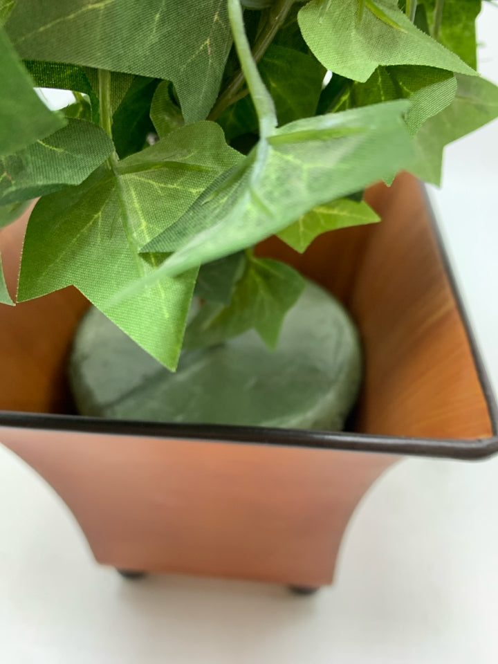 FAUX IVY TREE IN ORANGE METAL PLANTER.