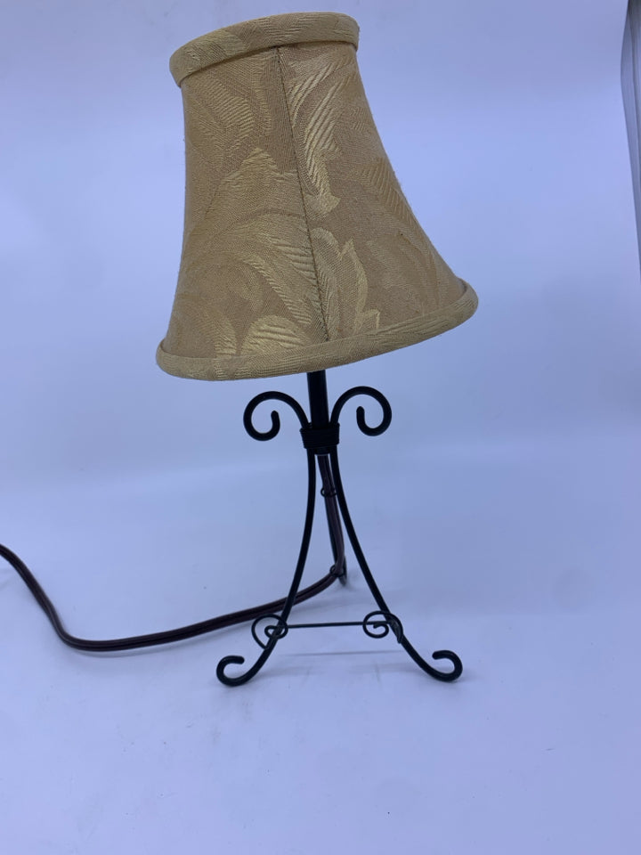 SMALL BLACK WROUGHT IRON TABLE LAMP WITH TAN SHADE.