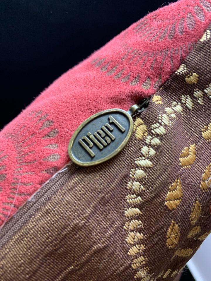 RED/BROWN CIRCLE STITCHED PILLOW.
