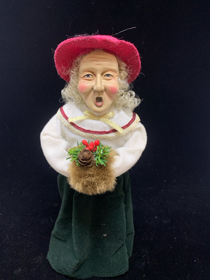 OLDER WOMAN SINGING CAROLER W/RED HAT.