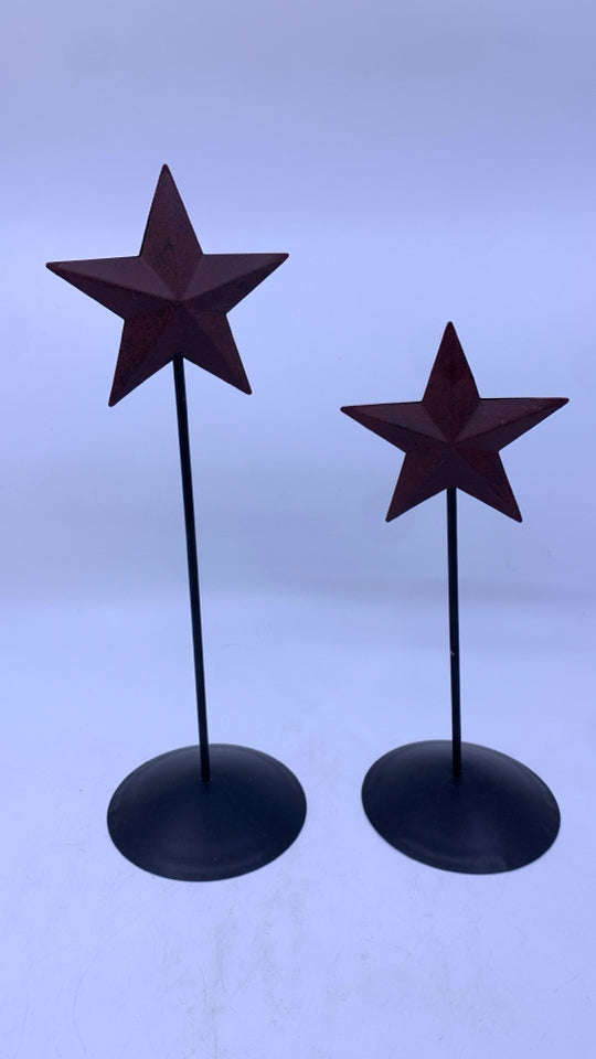 2 MAROON METAL STARS ON BLACK STANDS.
