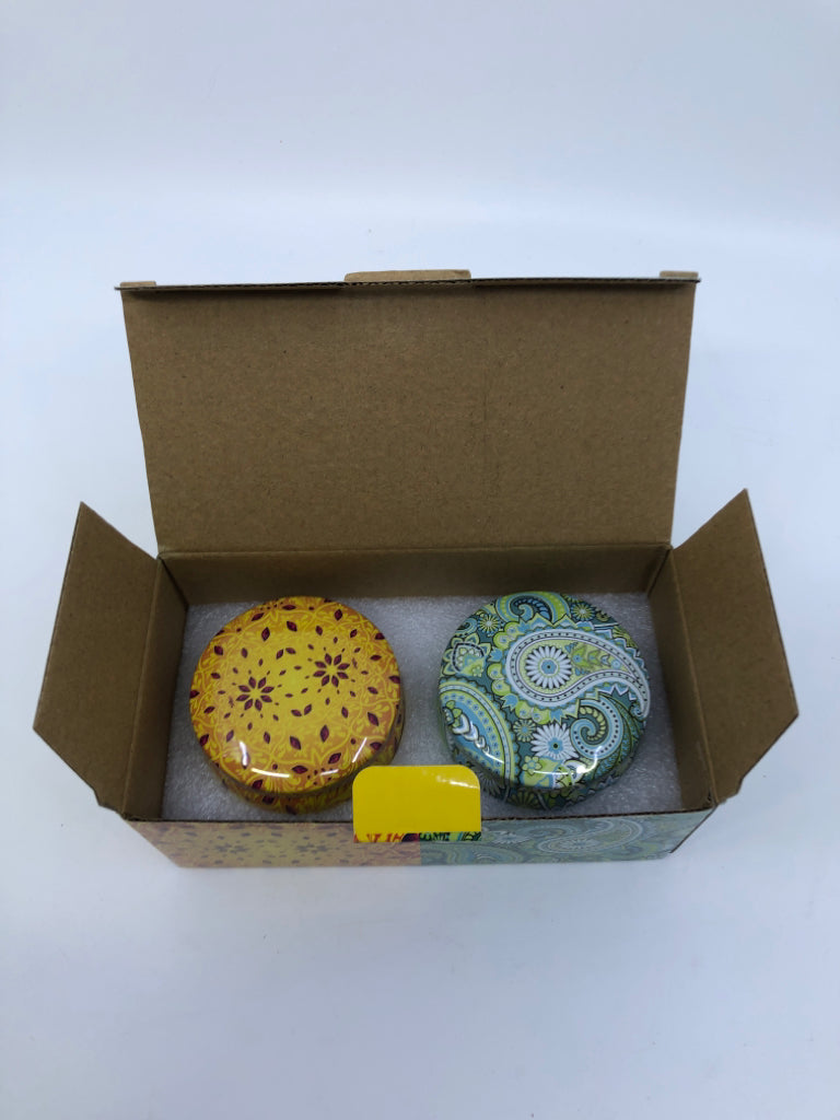 2 NIB SCENTED TIN CANDLES.