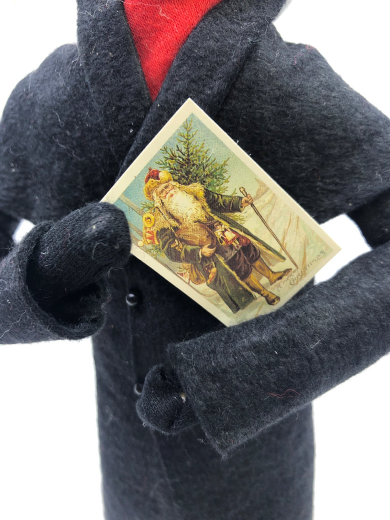 BYERS' CHOICE MAN HOLDING SANTA CARD-1991.