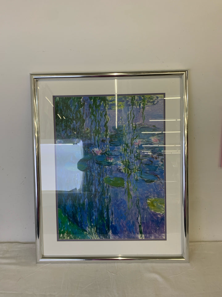 ABSTRACT LILY POND SCENE WALL HANGING IN SILVER FRAME.