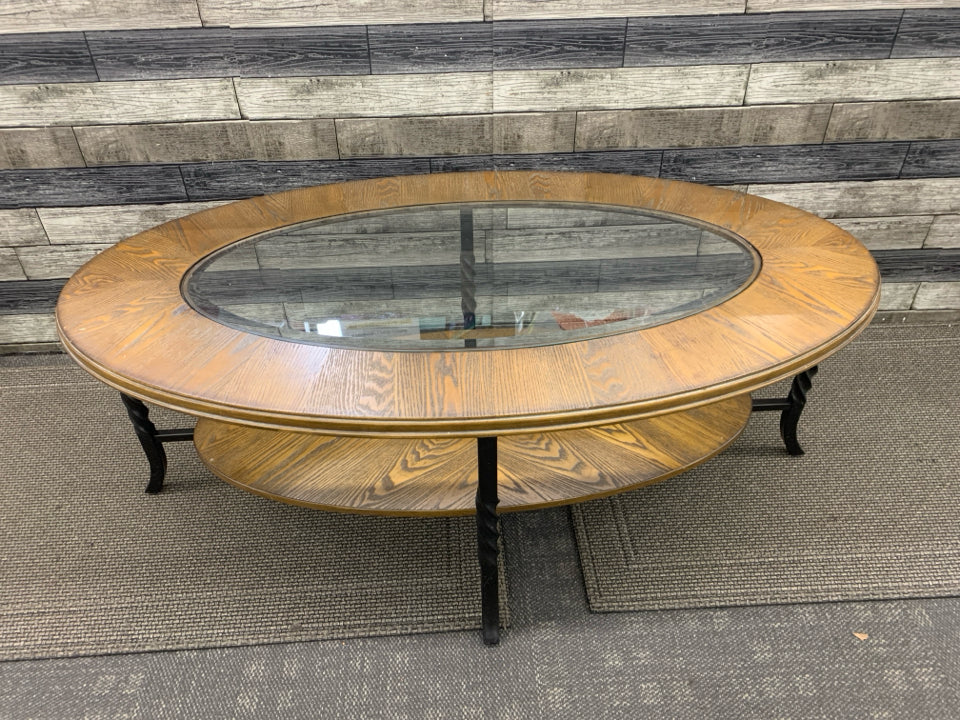 OVAL WOOD W GLASS TOP AND BOTTOM STORAGE COFFEE TABLE.