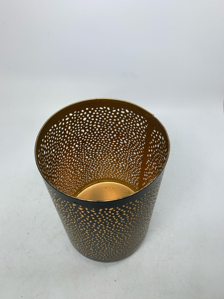 FOOTED METAL PIERCED PILLAR CANDLE HOLDER.