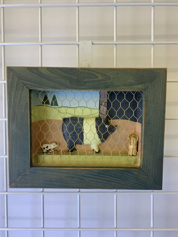 PRIMITIVE PIG IN GREEN FRAME WALL ART.