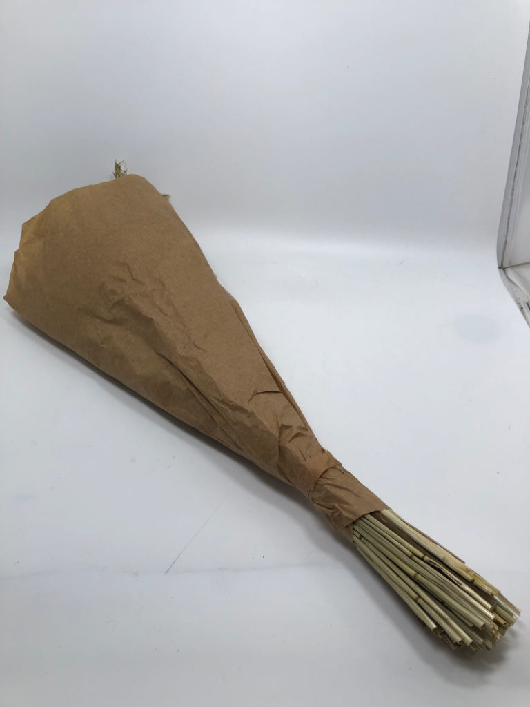 FAUX ROSE AND WILDFLOWER BOUQUET WRAPPED IN PAPER.