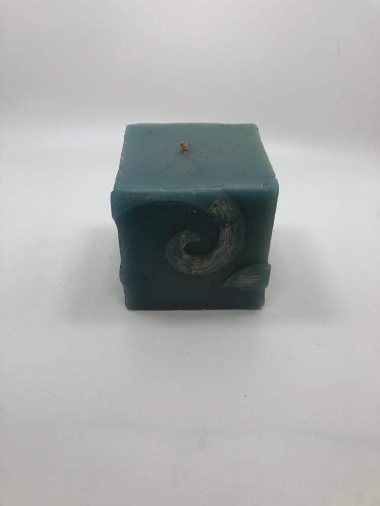 POTPOURRI DESIGNS SQUARE BLUE CANDLE W/FLORAL ETCHINGS.