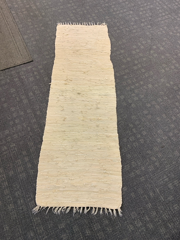 WOVEN FABRIC BEIGE RUG.