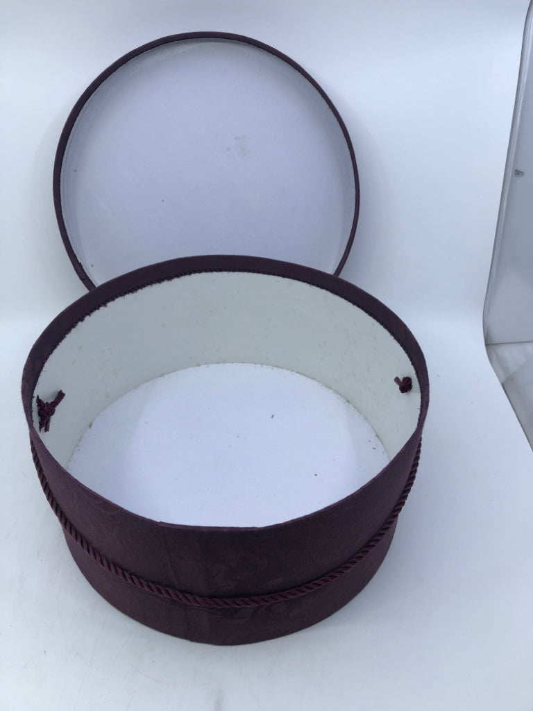 2 NESTING PURPLE FABRIC CIRCLE HAT BOXES.
