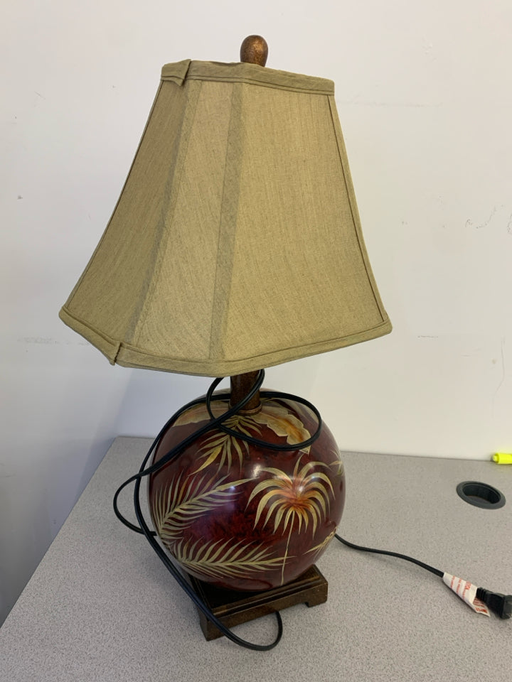 MAROON TROPICAL PALM ROUND GLASS TABLE LAMP WITH GOLD SHADE.