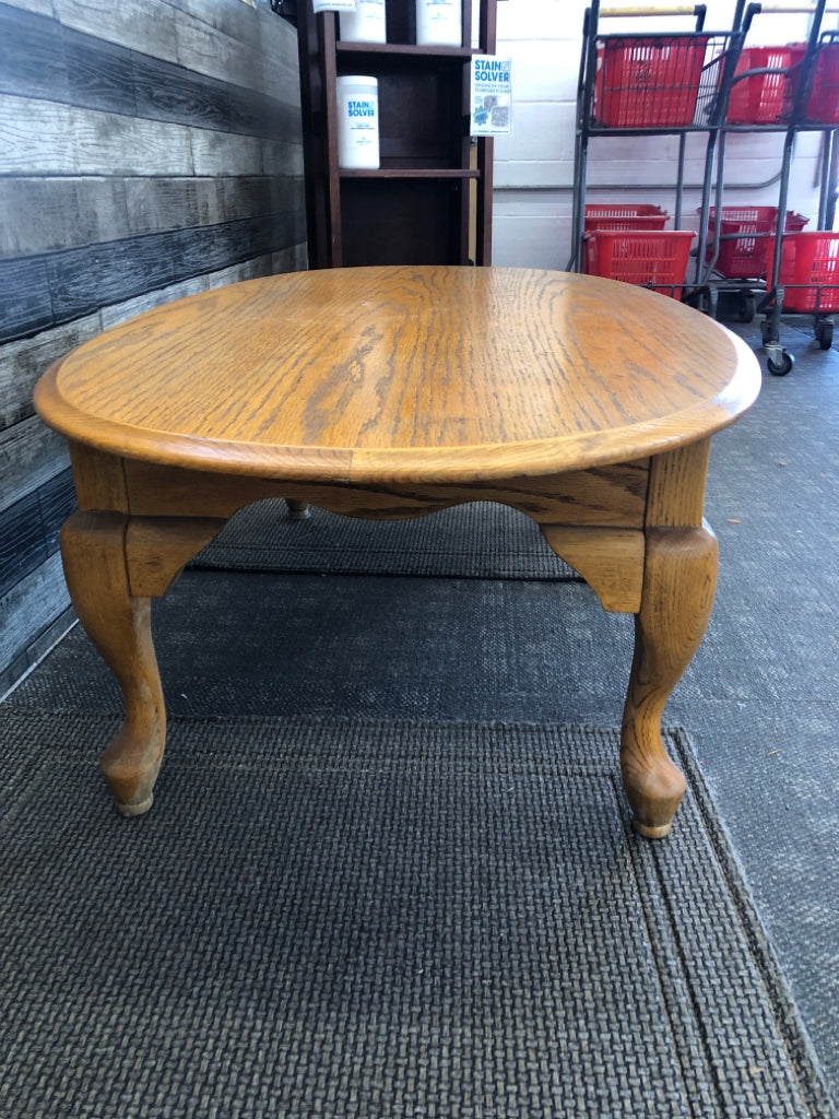 OAK WOOD OVAL COFFEE TABLE .