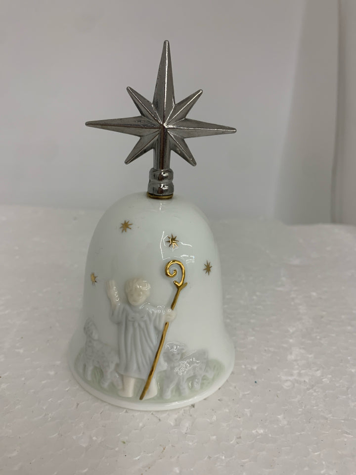 CERAMIC BELL W/ EMBOSSED BOY HERDING SHEEP METAL STAR AS HANDLE.