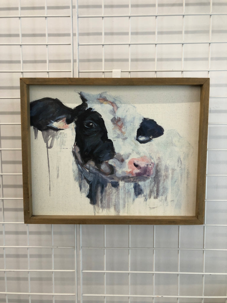 PAINTED COW IN UNFINISHED WOOD FRAME.