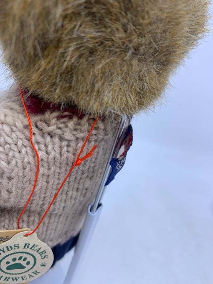 LIGHT BROWN BEAR W/ BEIGE SWEATER BLUE PANTS ON STAND.