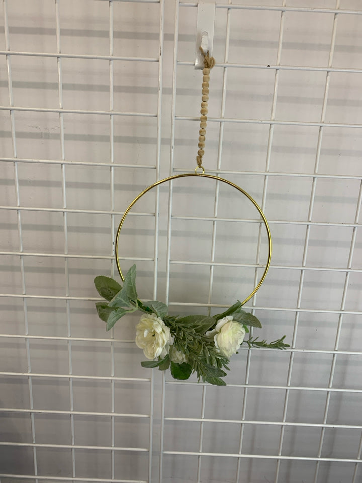 FAUX WHITE FLOWERS ON GOLD RING WREATH.