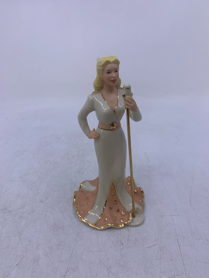 BLONDE WOMAN W/ MICROPHONE "A LONG WAY FROM HOME".