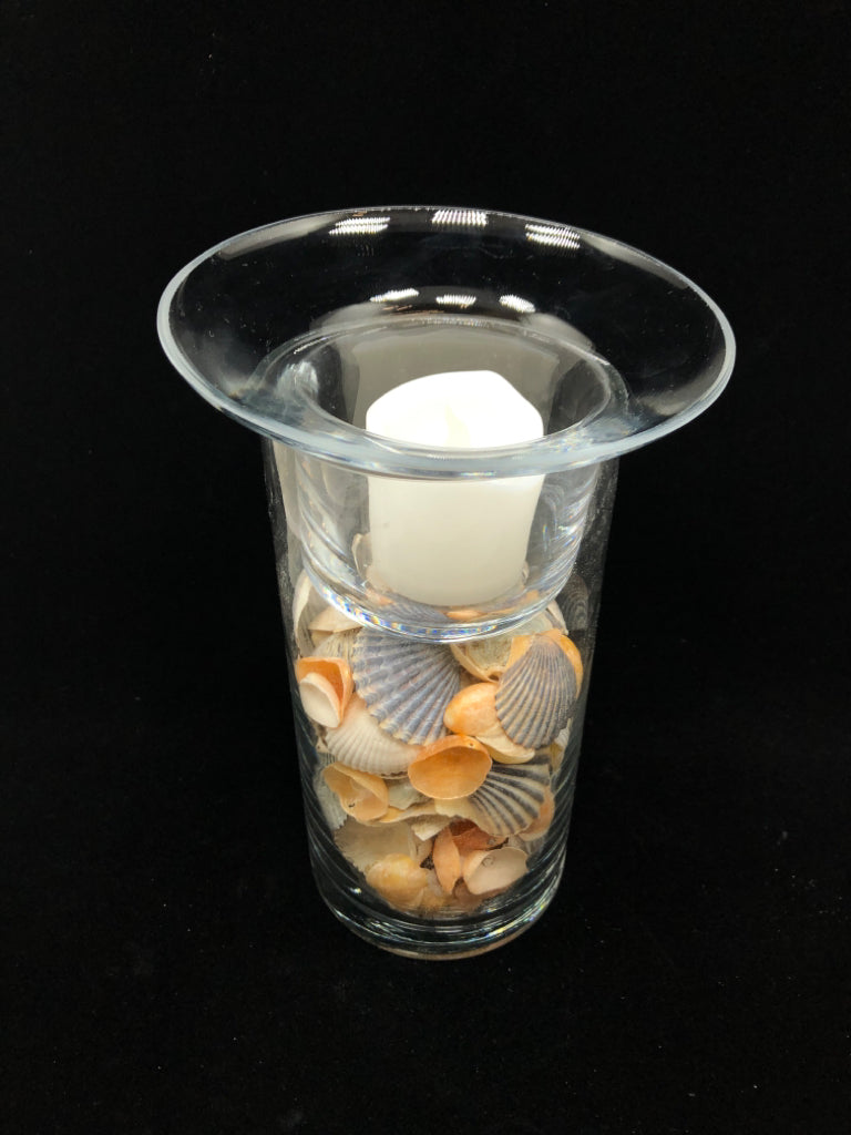 SEASHELL FILLED GLASS CANDLE HOLDER.
