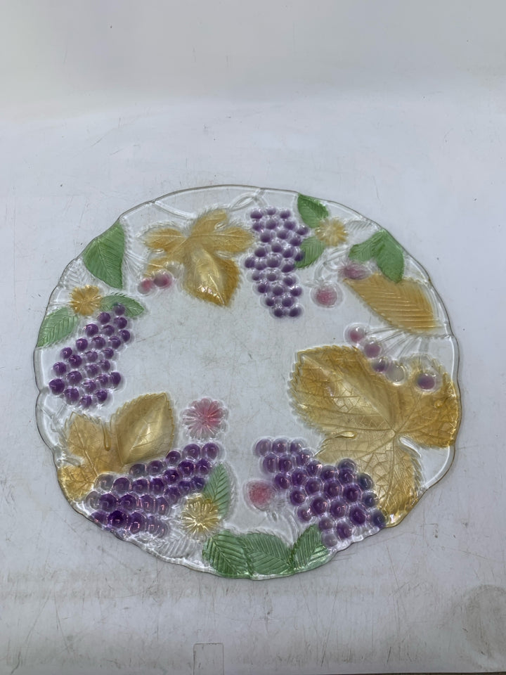 GLASS PLANTED W/ ASSORTED COLORED FRUIT.