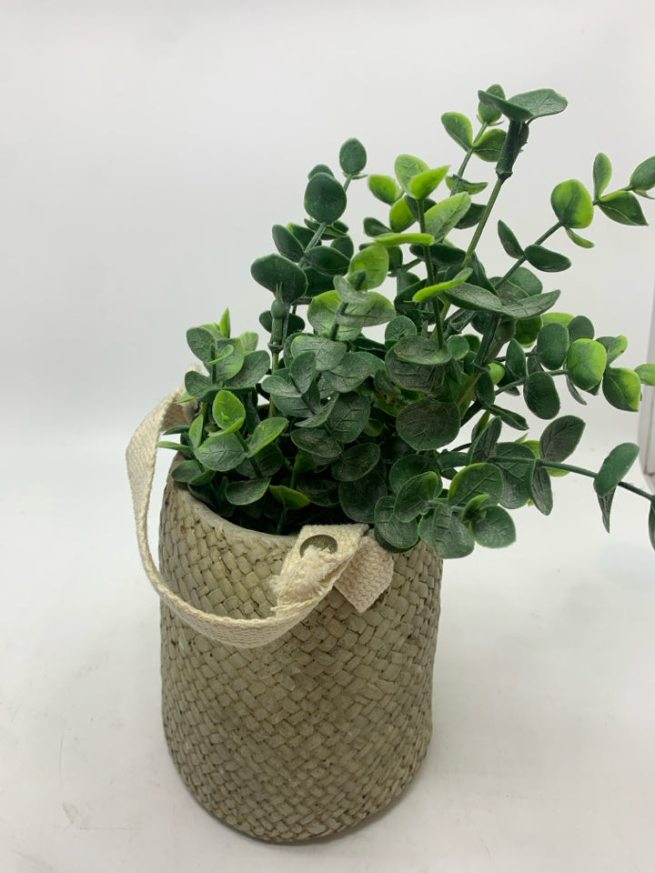 FAUX EUCALYPTUS IN RESIN BAG PLANTER.