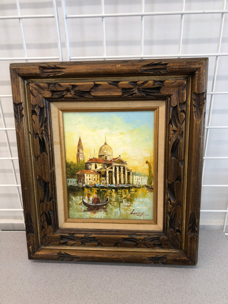 PAINTED MAN ON BOAT W/CHURCH? IN CARVED WOOD FRAME.