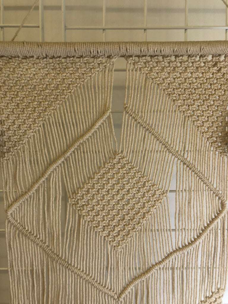 MACRAME WALL HANGING ON DOWEL W/ LARGE TASSELS.
