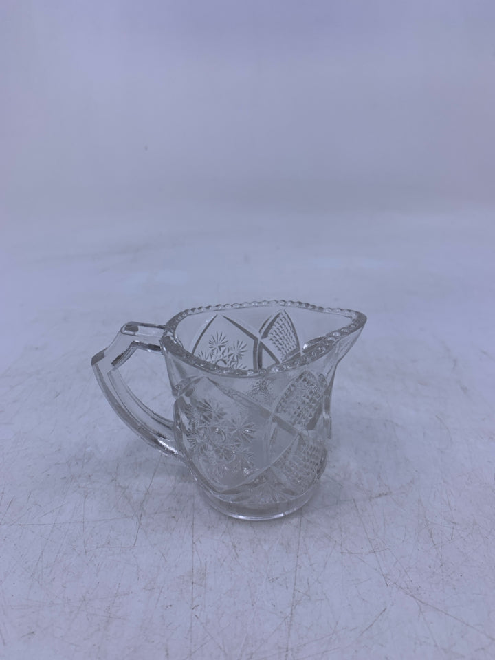 GLASS PITCHER W/ EMBOSSED STAR BURST TOOTH PICK HOLDER.