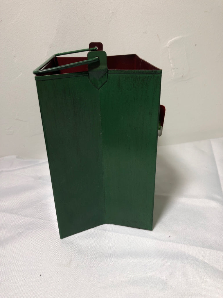 GREEN METAL PIERCED BAG CANDLE HOLDER W HANDLES.