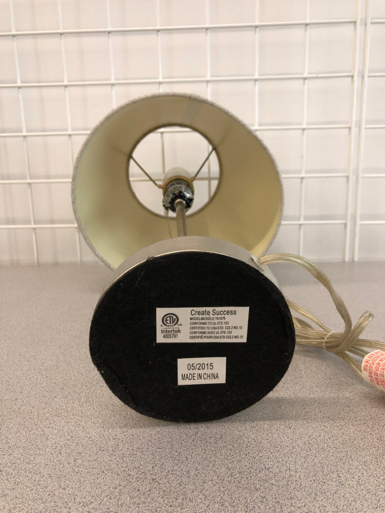 METAL LAMP W/GRAY FABRIC SHADE.