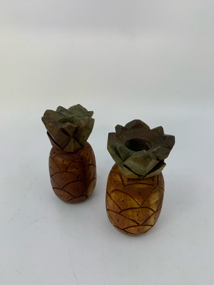 2 WOOD CARVED PINEAPPLE TAPERED CANDLE HOLDERS.