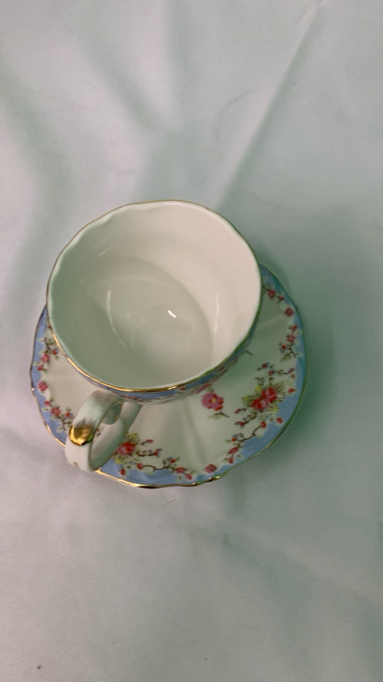 LIGHT BLUE W PINK FLORAL TEACUP AND SAUCER.
