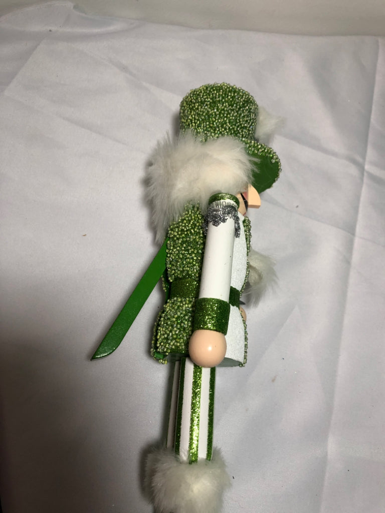 GREEN AND WHITE GLITTER NUT CRACKER.