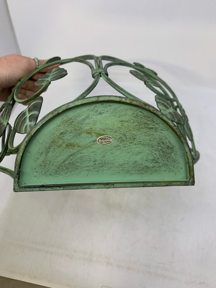 GREEN METAL WALL POCKET W/ LEAVES.