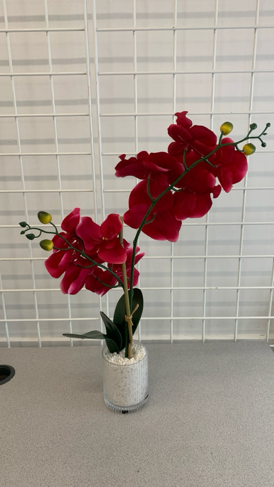 HOT PINK FAUX ORCHID IN RIBBED GLASS VASE.
