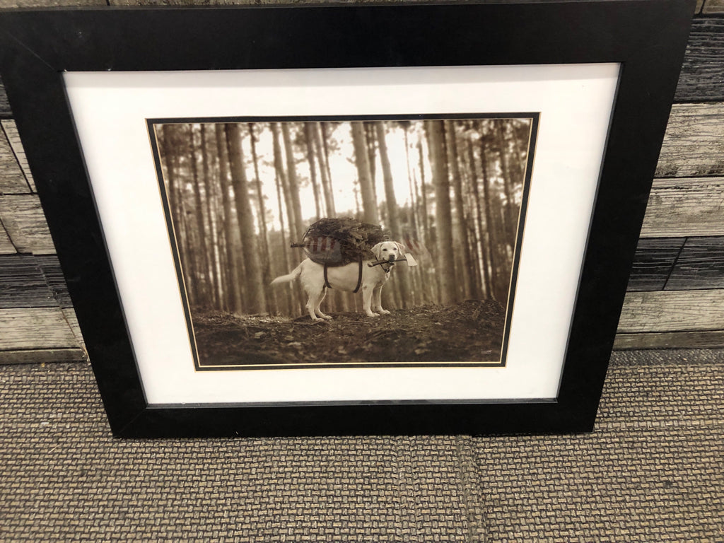 DOG CUTTING DOWN TREE IN BLACK FRAME WALL ART.