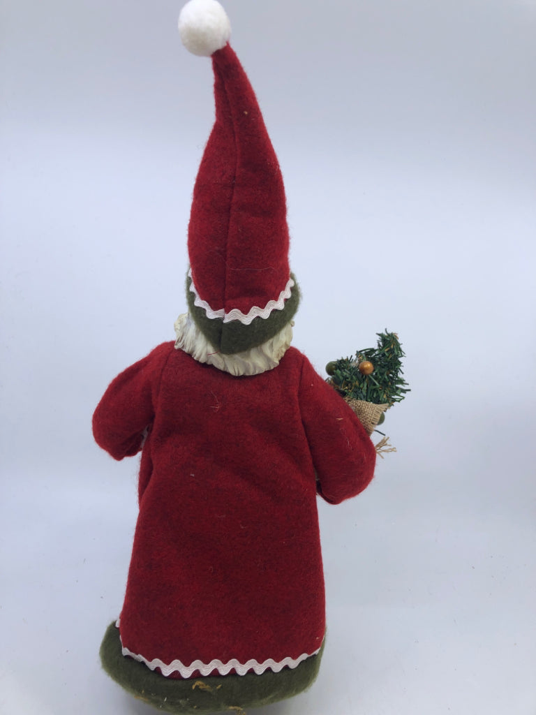 RESIN SANTA W/ RED COAT HOLDING CHRISTMAS TREE.
