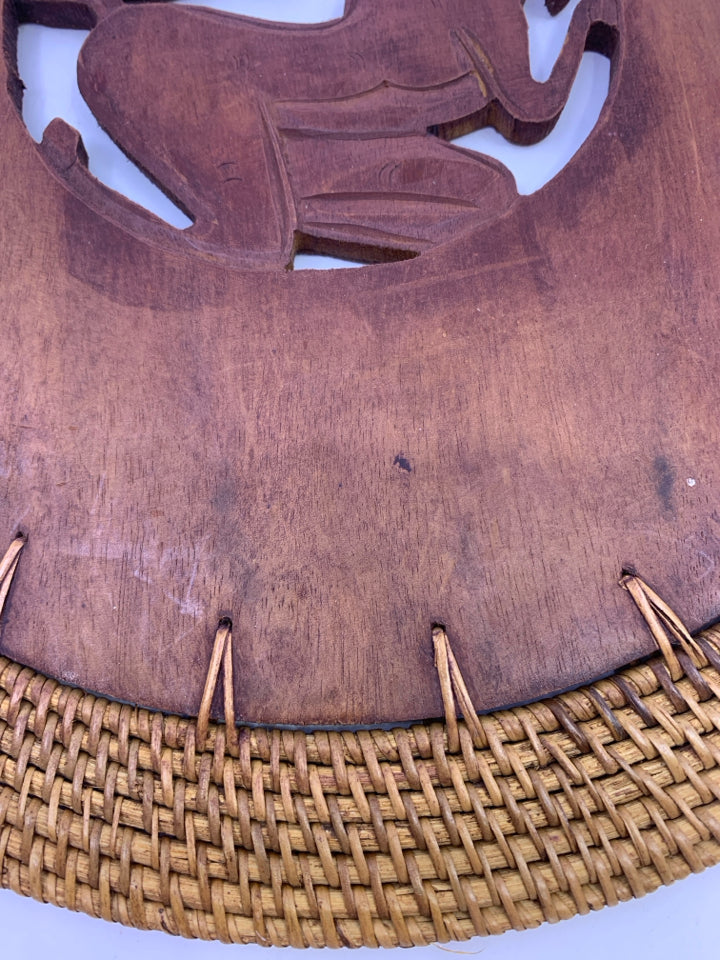 ROUND WOOD TRIVET CARVED ANIMAL DESIGN.