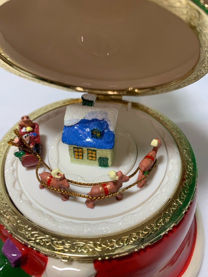 CERAMIC SANTA MUSIC BOX W/ REINDEER PULLING SLAY INSIDE.