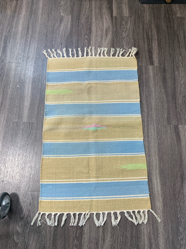 ASSORTED COLORS WOVEN AZTEC PATTERN RUG W/ TASSELS.