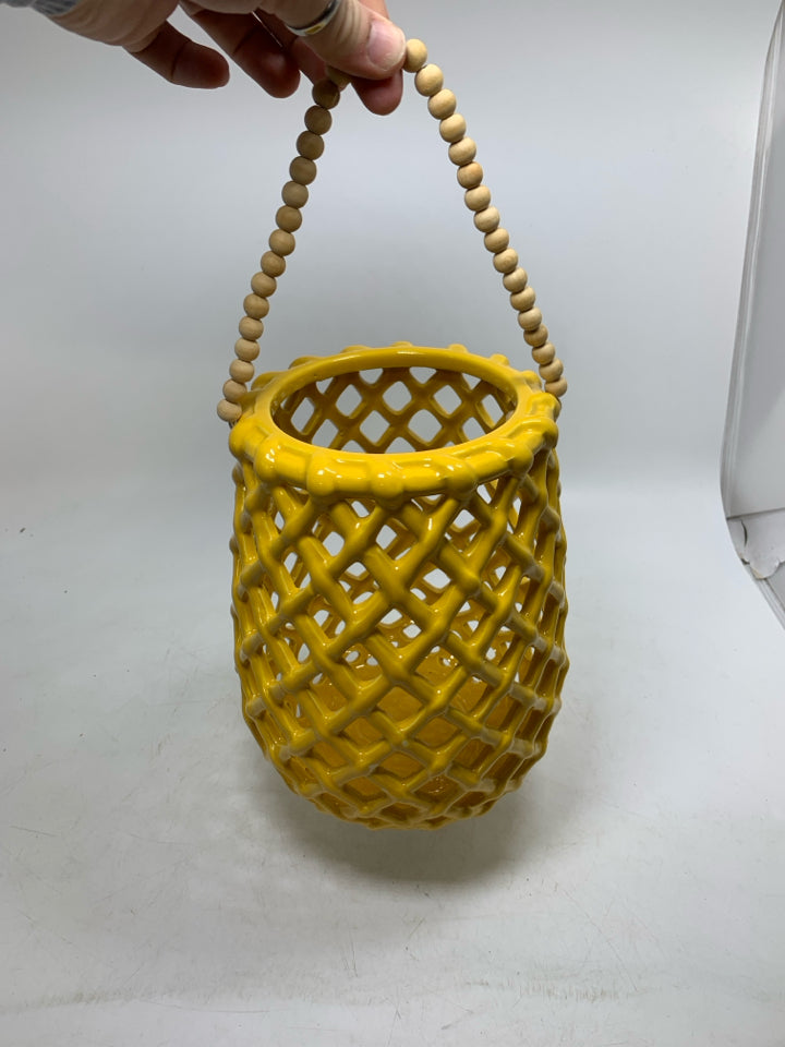 CERAMIC SLOTTED HANGING LANTERN W/ BEADED HANDLE.