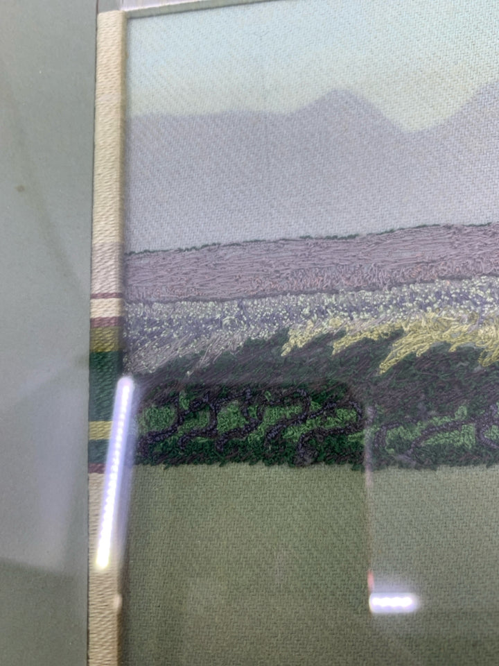 YARN EMBROIDERED GREENS LANDSCAPE IN SILVER FRAME.