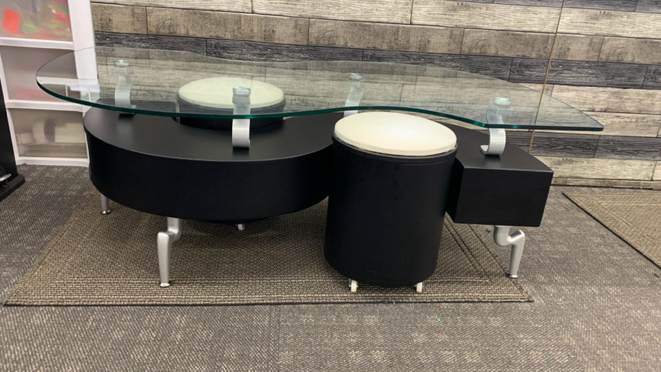 MODERN S-SHAPED GLASS TOP COFFEE TABLE W/ROLLING STORAGE SEATS.
