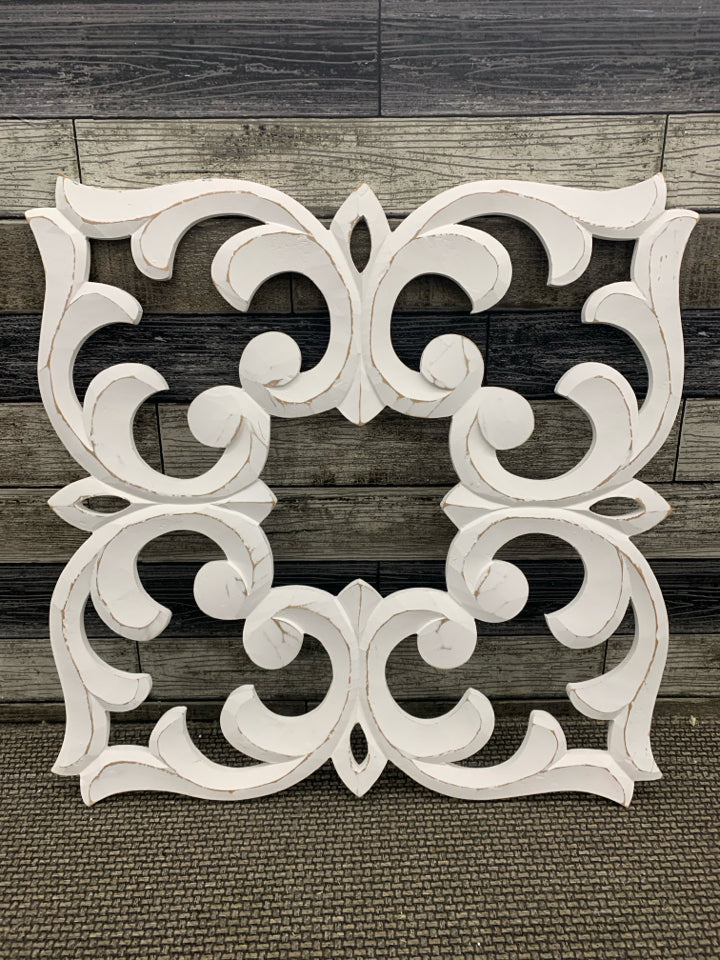 DISTRESSED WHITE WOODEN SCROLLWORK WALL PANEL.