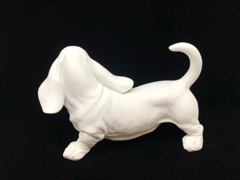 WHITE CERAMIC DOG FIGURINE.