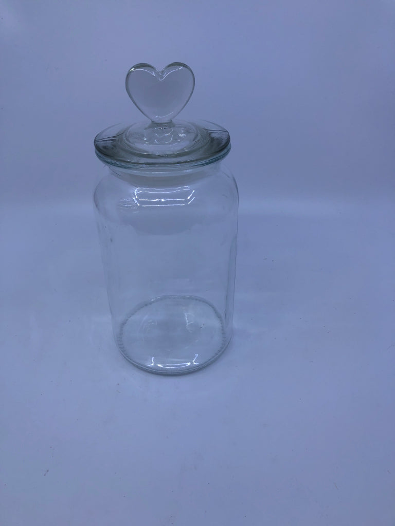 CLEAR GLASS CANISTER W/ HEART TOP HANDLE.